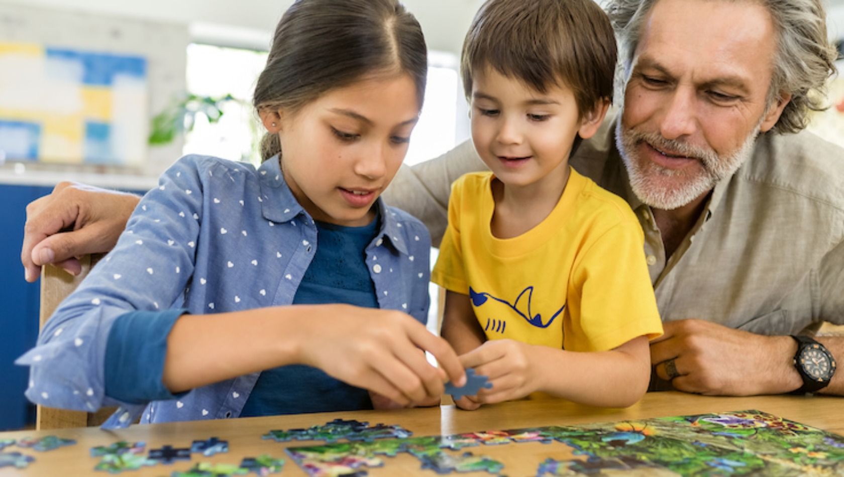 Eine Familie beim Puzzlen im Ravensburger Spieleland